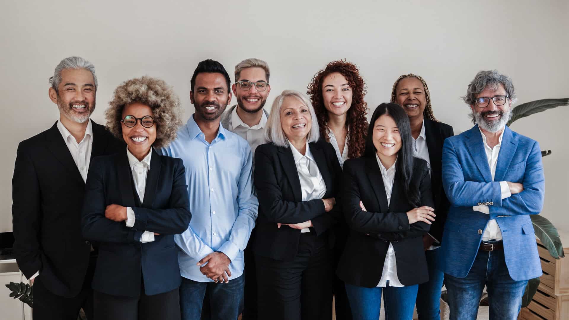 multi ethnic generational modern office: successful business team smiling on camera focus on asian girl face